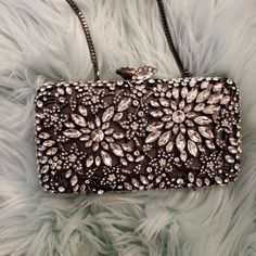 Glint Crystal Floral Clutch Size: 7"W X 3 ¾"H X 1 ½"D | Length: 20 1/2" Shoulder Strap Drop. | Wt: 1.3 Lbs. Nwot | Comes With Bonus Extra Crystals! Details & Care Ornate Floral Filigree Encrusted With Shimmering Crystals Makes This Petite Clutch An Elegant Evening Standout. *Magnetic Closure *Optional Drop-In Chain Strap *Lined *Glass/Acetate/Metal Chic Formal Bags With Silver Accents, Luxury Silver Clutch For Night Out, Silver Rhinestone Clutch For Gala, Chic Silver Bags For Gala, Chic Silver Bag For Gala, Luxury Silver Evening Bag For Night Out, Glamorous Silver Evening Bag For Gala, Formal Silver Sparkling Clutch, Evening Bags With Silver Accents, Rectangular Shape