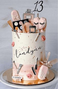 a birthday cake decorated with makeup and cosmetics