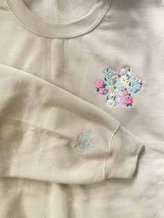 Custom  floral pet paw embroidered sweatshirt with pet name on sleeve,  EMBROIDERY DESCRIPTION : -Paw floral Embroidery is pocket placement, *Choose your sleeve  placement in personalization option: left or right sleeve? inner sleeve, outter sleeve, center of sleeve?  with added heart ! ( if not chosen your name will be embroidered on right center of sleeve )!  *please be as specific as possible so I can place your embroidery where you want it ! any questions please ask   *THREAD COLOR FOR SLEEV Long Sleeve Tops With Custom Embroidery For Everyday, Customizable Cute Cotton Sweatshirt, Cute Cream Cotton Sweatshirt, Cute Cotton Sweatshirt With Custom Embroidery, Custom Embroidery Spring Tops As Gift, Custom Embroidered Tops As Spring Gift, Spring Custom Embroidered Top As Gift, Custom Embroidered Top For Gift In Spring, Spring Cotton Sweatshirt Gift