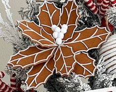 an ornament is hanging on a christmas tree with decorations and candy canes