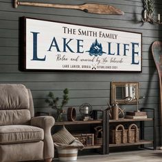 a living room filled with furniture and a large lake life sign hanging on the wall