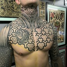 a man with tattoos on his chest and neck