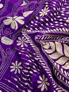 Gorgeous Purple color saree with handwoven Kantha stitch work in white color. Item: SareeColor : Purple Color with White threadBase Fabric: Bangalori Silk Blouse piece : YesBlouse material: Bangalori Silk Fall & Edging (Yes/No) : Yes Disclaimer -:- Color variation is possible due to various reasons like phone or desktop setting, resolution etc. Please don't hold us responsible. Our aim is to put the exact color of the Saree.- Colors are very Subjective. Hence a color understood by us can be diff Purple Embroidered Fabric With Zari Work For Traditional Ceremonies, Traditional Purple Saree With Chikankari Embroidery, Traditional Purple Blouse Piece With Chikankari Embroidery, Festive Purple Dupatta With Motifs, Purple Embroidered Fabric With Zari Work For Navratri, Unstitched Purple Blouse Piece With Chikankari Embroidery, Purple Blouse Piece With Resham Embroidery For Puja, Purple Resham Embroidery Dupatta For Traditional Ceremonies, Purple Dupatta With Resham Embroidery For Traditional Ceremonies