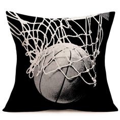 a black and white photo of a basketball going through the net on a pillow case