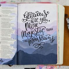 an open bible with the words glorious are you more majestic than the mountains