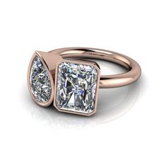 a rose gold engagement ring with two princess cut diamonds