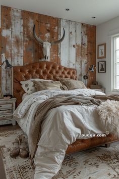 a bed room with a neatly made bed and a cow skull on the wall