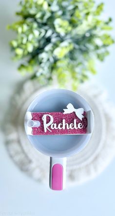 the name rachel is placed on top of a cup with a flower in the background