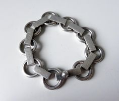 "An amazing piece of silver-smithing design history. A beautiful piece of Scandinavian design. Stunning bracelet designed by Scandinavian silver giant, Bent Knudsen for the silver-smithing company that he started in 1956.   c.1958-60 Heavy Sterling Silver bracelet (60) Condition excellent for a 60 year old piece of jewellery Weight 68.5 grams Length 7.5\" Width 18mm Hand made screw catch Bent Knudsen (1924-1997) worked at various gold and silversmiths in Copenhagen Denmark before he came to Hans Modernist Metal Bracelet Jewelry, Modernist Silver Jewelry With Oxidized Finish, Vintage Oxidized Sterling Silver Bracelet, Vintage Oxidized Sterling Silver Round Bracelet, Modernist Sterling Silver Bracelet, Handmade Silver Modernist Bracelets, Handmade Modernist Metal Bracelets, Handmade Metal Modernist Bracelets, Vintage White Gold Metal Bracelet