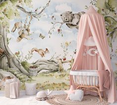 a baby's room with a mural and crib in the foreground, there is a teddy bear hanging from a tree