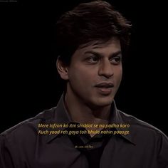 a man in a black shirt and tie looking at the camera with a quote on it