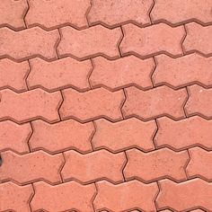 a black cat laying on top of a red brick sidewalk