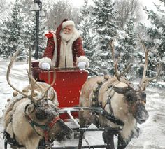 santa claus riding in a sleigh pulled by reindeers