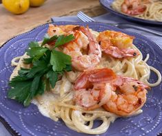 pasta with shrimp and parsley on blue plate