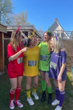 four girls in costumes are posing for the camera