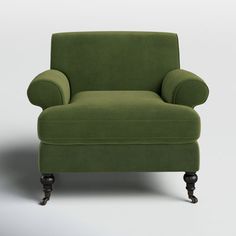 a green chair sitting on top of a white floor