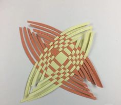 an orange and yellow piece of paper that has been cut into shapes with lines on it