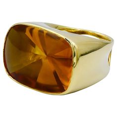 A beautiful cocktail ring made in 18kt yellow gold by Rinaldo Gavello. The center stone is a rectangular citrine weighing a total of approximately 40 carats. Gross weight 34.1 grams. Size 7. Resizing available depending on size. Engagement Rings Citrine, Amber Engagement Ring, Contemporary Ring, Citrine Ring, Modern Ring, Cocktail Ring, Modern Jewelry, Cocktail Rings, Citrine