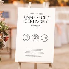 an unplugged ceremony sign with flowers in the background