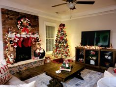 a living room decorated for christmas with stockings on the fireplace