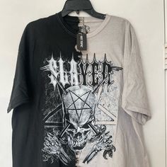 a t - shirt hanging up on a wall next to a hanger with an image of a skull