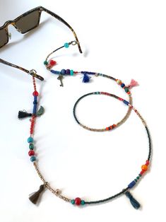 Unisex Bohemian Glasses Chain,Handmade Ethnic Sunglasses Cord,Key Charm Beaded Eye Glass Holder,Tussel Mask Chain,Gift for Her,Long Necklace If you are tired of playing hide and seek with your glasses and masks, there is a colorful news for you! Thanks to our handmade eyeglass straps, which make it almost impossible to lose glasses and give life to boring frames, you can wear your glasses comfortably by hanging them on your neck when not wearing them. It completes your full BOHO chic look! You c Adjustable Summer Jewelry With Tassels, Summer Festival Jewelry With Tassels, Multicolor Beaded Glasses Chains For Festival, Adjustable Tassel Jewelry For The Beach, Adjustable Tassel Jewelry For Beach, Bohemian Adjustable Glass Jewelry, Adjustable Bohemian Glass Jewelry, Bohemian Beach Jewelry With Tassels, Bohemian Style Adjustable Glass Jewelry