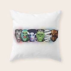 a white pillow with an image of four different monsters on the front and back of it