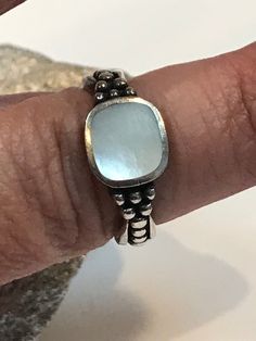 "This is a beautiful, vintage, genuine Mother of Pearl and sterling silver ring. The ring is a size 7 and could easily be resized by a jeweler if needed smaller or larger. The ring face is about 3/8\". The white mother of pearl is rectangular-cut and has a gorgeous luster. It measures about 3/8\" by nearly 1/3\". There is pretty sterling silver beading/balls on the sides. The ring weighs about 4.3 grams and is stamped CW 925. This is a showstopper! See pictures for details. More gorgeous jewelry Classic Sterling Silver Turquoise Ring For Anniversary, Silver Stackable Turquoise Ring For Anniversary, White Turquoise Sterling Silver Ring For Anniversary, Silver Stackable Moonstone Ring For Anniversary, Stackable Silver Moonstone Ring For Anniversary, Nickel-free Vintage Stackable Rings For Anniversary, Vintage Silver Turquoise Ring As Gift, Classic Turquoise Ring Stamped 925 For Anniversary, Vintage Silver Turquoise Ring Gift