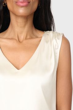 The Reverly Cinched Detail Satin Top is a sophisticated wardrobe staple. Crafted from luxe silky fabric, it features cinched shoulder details for subtle definition and a flattering V-neckline. Perfect for special occasions or a everyday look. Created in collab with @cassiesugarplum 96% Polyester | 4% Spandex Delicate Wash Cycle, Dry Flat. Length 25" (size small) Danielle is 5'3 wearing size XXS in Champagne. Sabrina is 5'7 and is wearing XXS in Black. Elegant Formal V-neck Top, Elegant Viscose V-neck Top For Spring, Chic Ruched Silk Tops, Sleeveless Silk Ruched Top, Sleeveless Ruched Silk Top, Sleeveless Silk Top With Ruched Detail, Elegant Sleeveless Ruched Tops, Elegant Ruched Blouse For Evening, Elegant Evening Top With Open Neckline