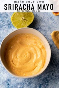 a bowl filled with homemade sriraca mayo sauce next to limes on the side