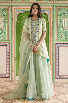 Powder green pure spun silk short kurta with high-low hem, contrast front panel, gold and silver zardozi hand embroidery. Paired with embroidered flared gharara and pure organza dupatta with scalloped embroidered cut work border.
Components: 3
Pattern: Hand Embroidered
Type Of Work: Zardozi Work
Neckline: U Neck
Sleeve Type: Half Sleeves
Fabric: Pure Spun Silk, Dupatta: Pure Organza
Color: Green
Other Details: 
Attached lining
Approx. product weight: 2 kg
Model height: 5ft 7inches, wearing size Zardozi Work, Short Kurta, Silk Kurta, Organza Dupatta, Silk Dupatta, Silk Shorts, U Neck, Cut Work, Embroidered Silk