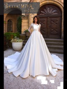 a woman standing in front of a building wearing a wedding dress