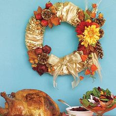 a table topped with a turkey next to a wreath