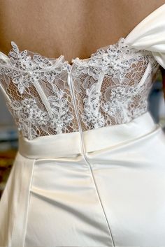 the back of a woman's white wedding dress