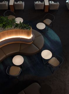 an overhead view of a restaurant with tables, chairs and potted plants in the center