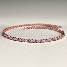 This Pink Sapphire & Diamond Alternate Tennis Bracelet in 14K rose gold combines the vibrant allure of natural pink sapphires with the brilliance of lab-grown diamonds for a sophisticated, timeless design. Perfect as a luxurious Christmas gift, this bracelet brings together elegance and contemporary charm, offering a refined touch of color and sparkle that makes any occasion unforgettable. 𝐅𝐞𝐚𝐭𝐮𝐫𝐞𝐬: * 𝐌𝐚𝐝𝐞 𝐭𝐨 𝐎𝐫𝐝𝐞𝐫 * 𝐌𝐞𝐭𝐚𝐥: 𝟏𝟒𝐊 | 𝟏𝟖𝐊 * 𝐁𝐚𝐧𝐝 𝐂𝐨𝐥𝐨𝐫𝐬: Rose Go Pink Single Cut Round Diamonds Jewelry, Pink Round Cut Single Diamond Jewelry, Luxury Pink Diamond Bracelet With Accents, Pink Diamond Bracelet Fine Jewelry, Pink Fine Jewelry Tennis Bracelet, Pink Diamond Bracelet For Wedding, Luxury Pink Diamond Bracelet For Anniversary, Pink Diamond Tennis Bracelet In Fine Jewelry Style, Pink Diamond Tennis Bracelet Fine Jewelry