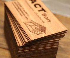 stack of wooden business cards sitting on top of a table