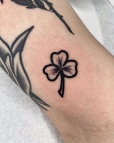 a close up of a person's arm with a flower and bird on it