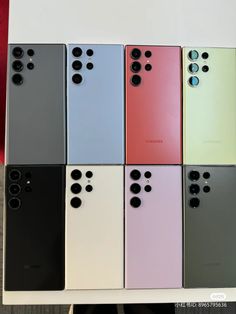 several different colors of cell phones sitting next to each other