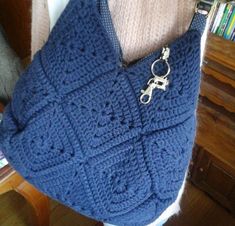 a blue purse with a keychain hanging from it