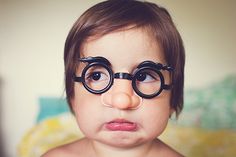 a young child with glasses on his face