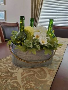 a table with some bottles and flowers in it