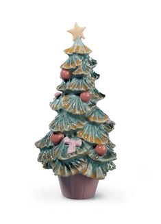 a ceramic christmas tree sitting on top of a cupcake