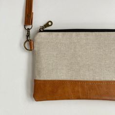 "This small crossbody bag for women is compact & lightweight while still offering plenty of room to carry essential items like your cash & bank cards, phone, and keys while you run errands or go out with friends. It's perfect for women who love a small bag, but also want to be hands-free. Use it as an every day handbag or travel bag and enjoy the ease of an adjustable strap that enables you to wear it crossbody or over-the-shoulder.  SIZE:  9\" wide x 6\" high, crossbody strap is adjustable up to 50\" long Features -  * exterior is made with oatmeal flax linen and caramel brown vegan leather  * interfaced to give it structure and durability * detachable crossbody strap in matching vegan leather * interior lining is made using coordinating cotton in ivory * 6 credit card slots to keep you o Mobile Phone Bag Pouch For On-the-go, Everyday Clutch Pouch For Mobile Phones, Beige Clutch Shoulder Bag With Cell Phone Pocket, Daily Use Zipper Pouch Bag, Zipper Pouch Bags For On-the-go, Crossbody Wallets With Mobile Phone Bag For Everyday, Travel Crossbody Clutch With Adjustable Strap, Crossbody Clutch As A Gift, Beige Clutch Phone Bag For Everyday Use