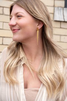 Our Tatiana Earrings, featuring a gold tassel dangle, are coming in hot, and they are going to be your new faves! They're ultra lightweight, so you can wear them all day and night without feeling weighed down – but trust us, they still pack a punch. You'll feel like you're walking down the runway every time you wear them. The playful tassel sways with every movement and adds just the right amount of flirtatious fun to your look. 18k gold-plated stainless steel Hypoallergenic Tarnish resistant Wa Linear Tassel Dangle Earrings, Chic Gold Tassel Drop Earrings, Long Drop Fringe Tassel Earrings, Minimalist Gold Tassel Drop Earrings, Chic Gold Dangle Tassel Earrings, Trendy Gold Fringe Earrings, Trendy Gold Tassel Earrings With Fringe, Adjustable Tassel Earrings With Latkans, Minimalist Tassel Earrings