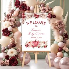 a welcome sign surrounded by balloons and flowers