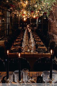 a long table is set with candles and place settings for an elegant dinner or party