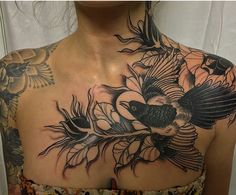 a woman with tattoos on her chest and back is wearing a dress that has flowers in it