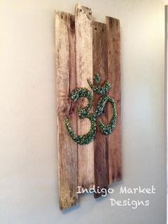 a wooden wall hanging with an om sign on it