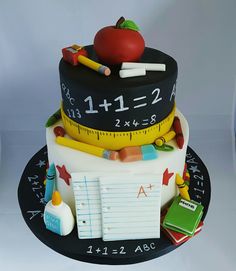 a cake made to look like a teacher's desk with a ruler and apple on top